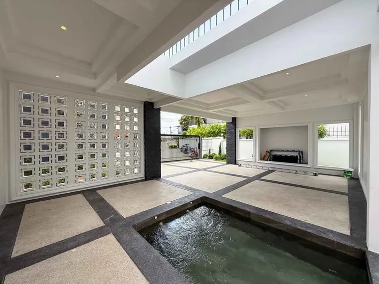 Inner courtyard with a patterned breeze-block screen, a skylight and a sunken water feature.