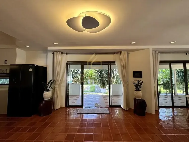 Open kitchen and dining area with terracotta floors and glass doors onto the garden.