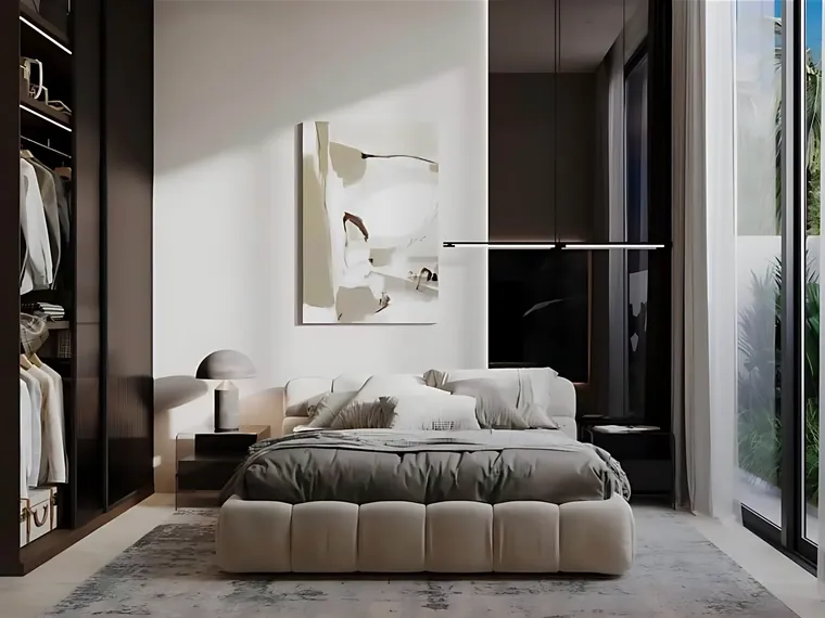 Bedroom with a walk-in wardrobe and floor-to-ceiling glass to the garden.